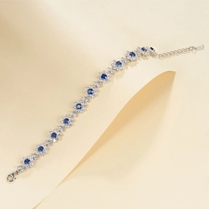 Luxurious S925 silver flower bracelet with emerald cut blue gems and white crystals
