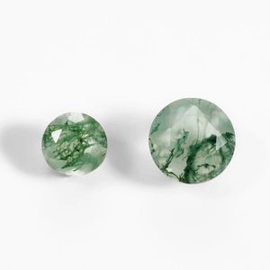 Natural round faceted moss agate gemstones with forest green inclusions on white background