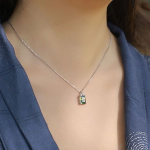 Rectangular green moss agate pendant on S925 sterling silver chain worn by a model