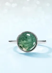 Macro shot of circular moss agate stone with unique green textures in S925 silver ring