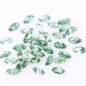 Macro shot of marquise-cut natural moss agate stones with green moss-like inclusions