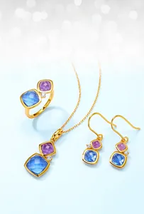 Close-up of S925 silver jewelry set with square candy colored crystals and gold plating