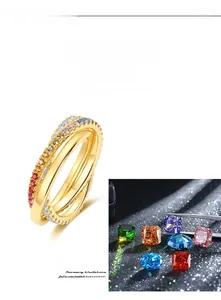 Detail of 18K gold double-layer ring with polished band and rainbow cubic zirconia