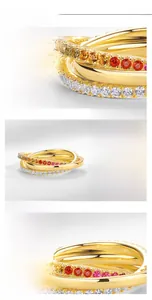 Macro detail of S925 silver interlocking rings with rainbow cubic zirconia and gold plating