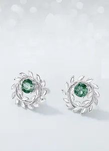 Macro shot of silver olive branch stud earrings with green moss agate stone detail
