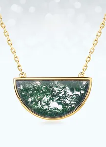 Macro detail of the semi-circular moss agate pendant with golden chain necklace