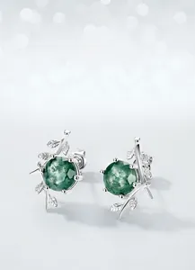 Detail shot of S925 silver olive branch earrings with natural green moss agate stones