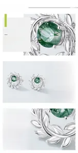 Macro detail of leaf-shaped S925 silver earrings with inlaid green moss agate stones