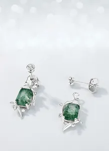 Macro view of S925 silver vine detail and moss agate gemstone on the stud earring
