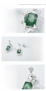 Macro detail of S925 silver earrings with green moss agate and natural plant texture
