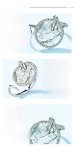 Macro view of S925 silver snake ring scales and natural green moss agate stone