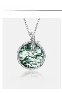 Detailed view of snake-wrapped green moss agate pendant with scale texture and emerald eyes