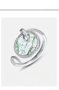 Close-up of S925 silver serpent ring with moss agate stone and green gemstone eyes
