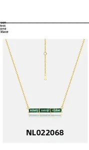 Macro detail of gold-plated necklace with three rectangular green moss agate stones