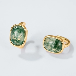 Elegant gold earrings with rectangular moss agate stones on a soft grey background