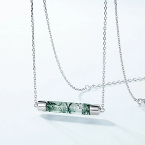 Minimalist S925 silver necklace with cylindrical green moss agate pendant on blue background