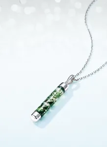 Macro shot of cylindrical natural moss agate pendant with s925 silver chain necklace