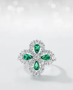 Close-up of S925 silver ring featuring pear-cut emeralds and white cubic zirconia stones