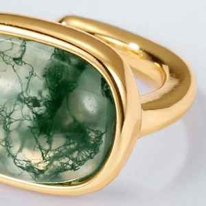 Elegant gold S925 silver ring with oval green moss agate stone on gray background