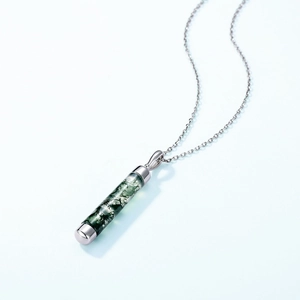 Minimalist S925 silver necklace with cylindrical green moss agate pendant on blue background