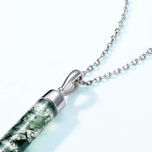 Macro shot of silver S925 cap and natural moss agate cylinder pendant details