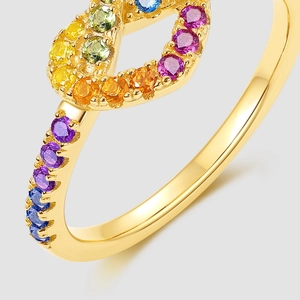 Macro shot of gold-plated rainbow cubic zirconia ring with vibrant gemstone inlay
