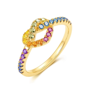 Gold heart design ring with colorful rainbow zircon stones on a white background