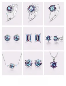 Macro shot of alexandrite jewelry set with silver geometric rings and pendants