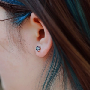 Close-up of S925 silver stud earring featuring hexagon cut alexandrite with six-prong setting