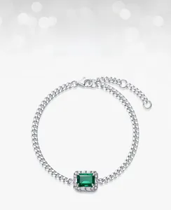 Macro shot of rectangular lab-grown emerald silver bracelet with zircon setting