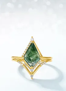 Macro shot of kite-cut moss agate ring with delicate diamonds in a gold-plated setting