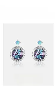 Close-up of alexandrite stud earrings with brilliant halo of high-carbon diamonds
