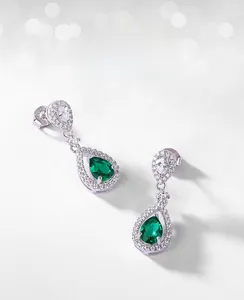 Detailed view of S925 silver hallmark on pear-cut emerald teardrop earrings