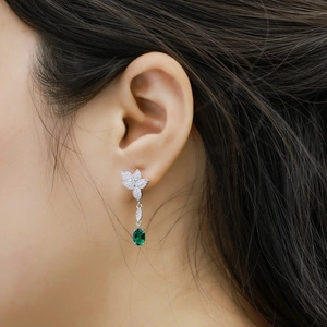 Elegant S925 silver drop earrings featuring oval emerald stones and clover leaf stud