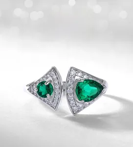Macro detail of fan-shaped S925 silver ring with triangle emerald and zircon inlay