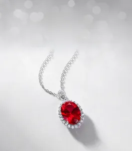 Macro shot of oval red ruby pendant with sparkling white diamond halo in S925 silver setting