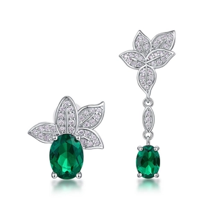 Asymmetric S925 silver earrings with emerald green gemstones and sparkling leaf details