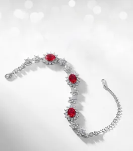 Detailed macro of S925 silver bracelet with oval red rubies and flower cluster diamonds