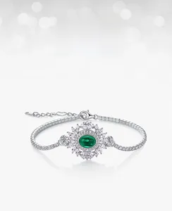 Macro detail of lab-grown emerald bracelet with sunflower halo and silver zircon inlay