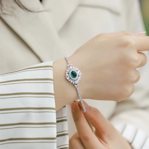 Vintage S925 silver emerald bracelet featuring an oval green gemstone with floral diamonds