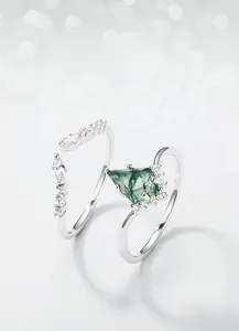 Macro detail of S925 silver kite-cut moss agate ring with sparkling accent zircons