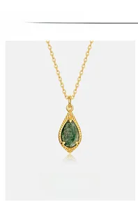 Detail view of pear-cut green moss agate pendant with retro bezel gold-plated setting