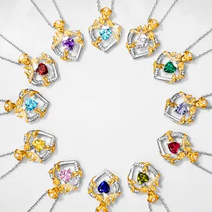 Detail view of heart-shaped birthstone pendants with silver roses and colorful crystals