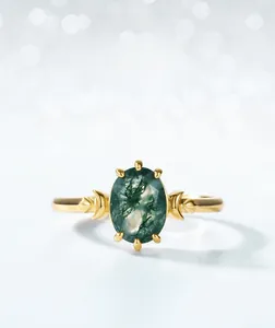 Detailed view of an oval moss agate ring with crescent moon accents on gold-plated band