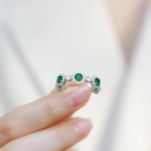 Luxurious S925 silver ring featuring three green emerald stones in halo diamond setting