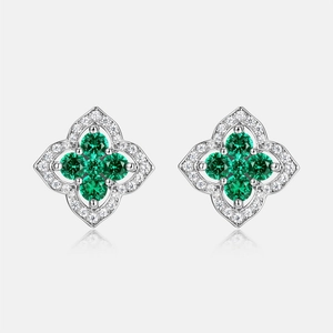 Silver four-leaf clover stud earrings with emerald center and halo diamonds
