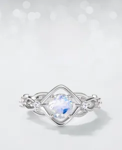 Macro detail of S925 silver ring featuring blue moonstone with diamond-accented infinity band