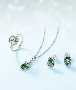 Detailed set of silver jewelry featuring rectangular green moss agate stones on blue background