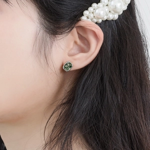 Square green moss agate stud earrings with textured silver frame shown on a model's ear