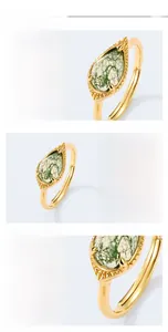 Detailed macro view of S925 silver gold-plated ring with teardrop green moss agate stone